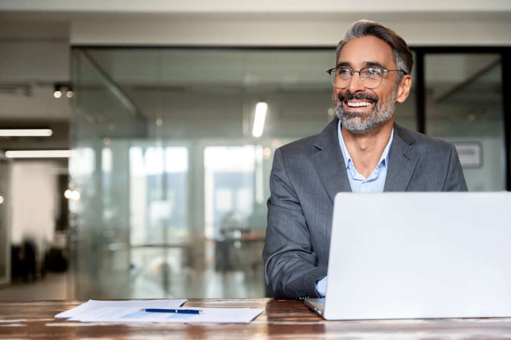 Full-time CFO reviewing financial reports at a desk in a corporate office