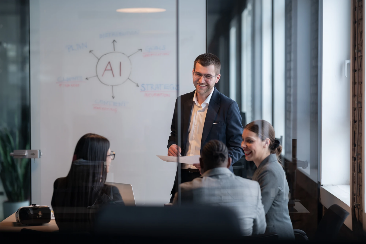 Outsourced accounting for AI companies Team working in a modern AI startup office reviewing financial data on screens