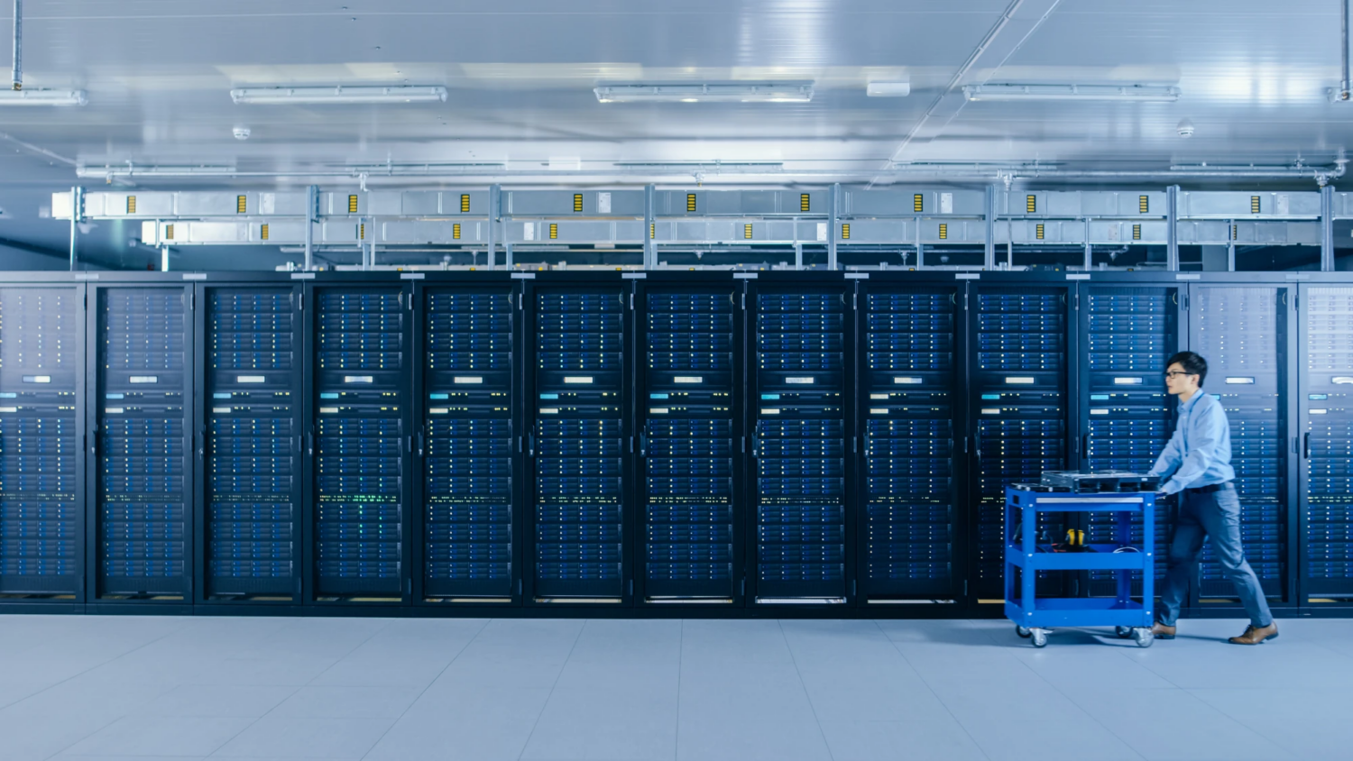 Outsourced accounting for data center companies Technician reviewing server racks inside a modern data center facility