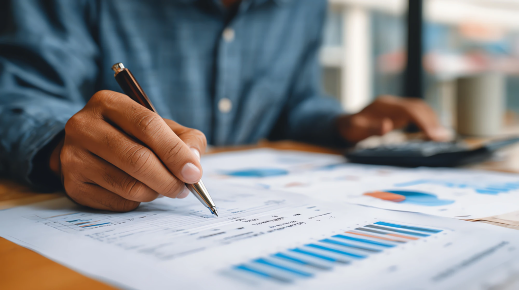 Outsourced CFO in Georgia Finance professional reviewing printed reports at an office desk