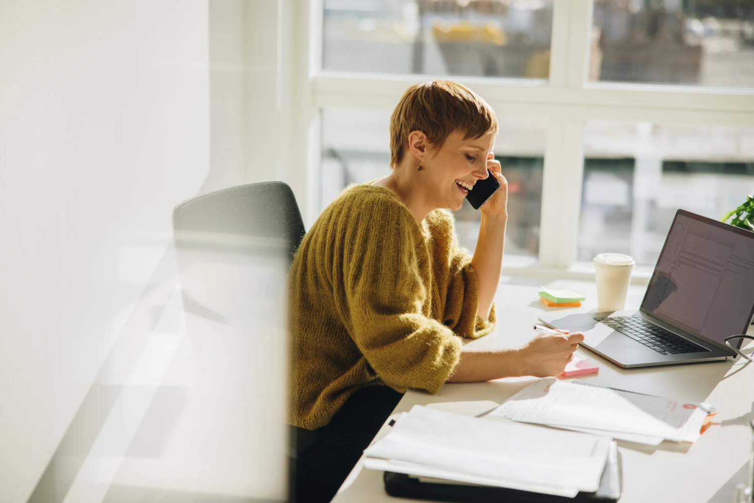 Small business owner meeting remotely with an outsourced CFO on a laptop