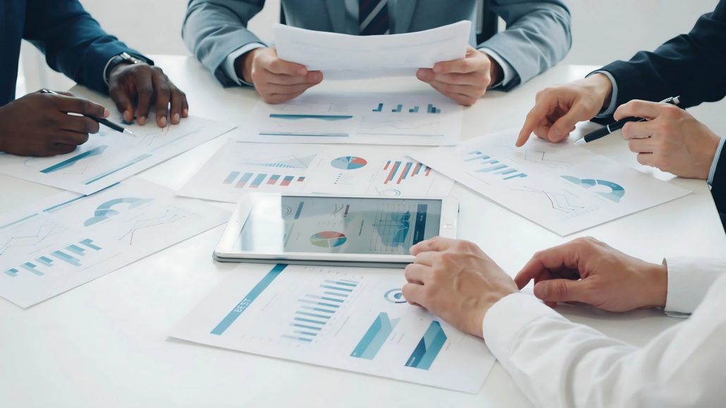 Fractional CFO in NYC Team of four in a glass-walled meeting room