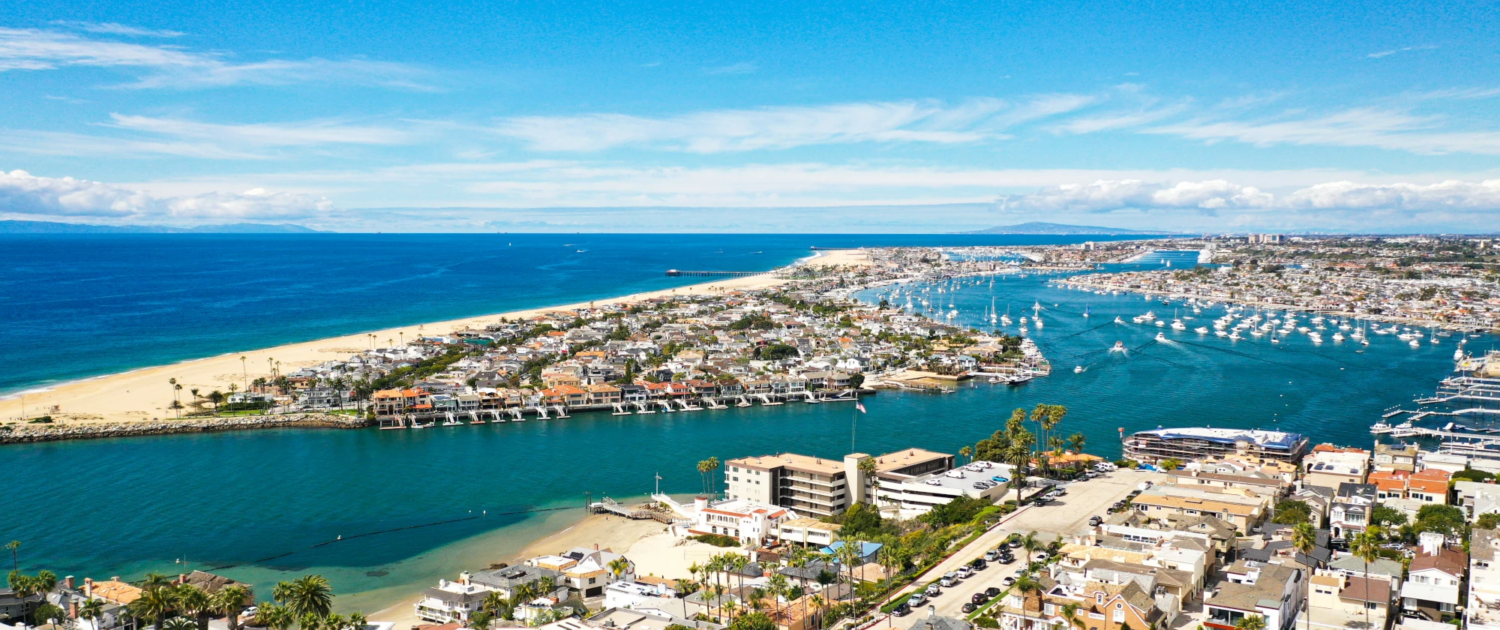 Outsourced CFO in Orange County The Newport Beach coastline and harbor at dusk