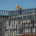 Construction worker installing metal framing on a building under construction.